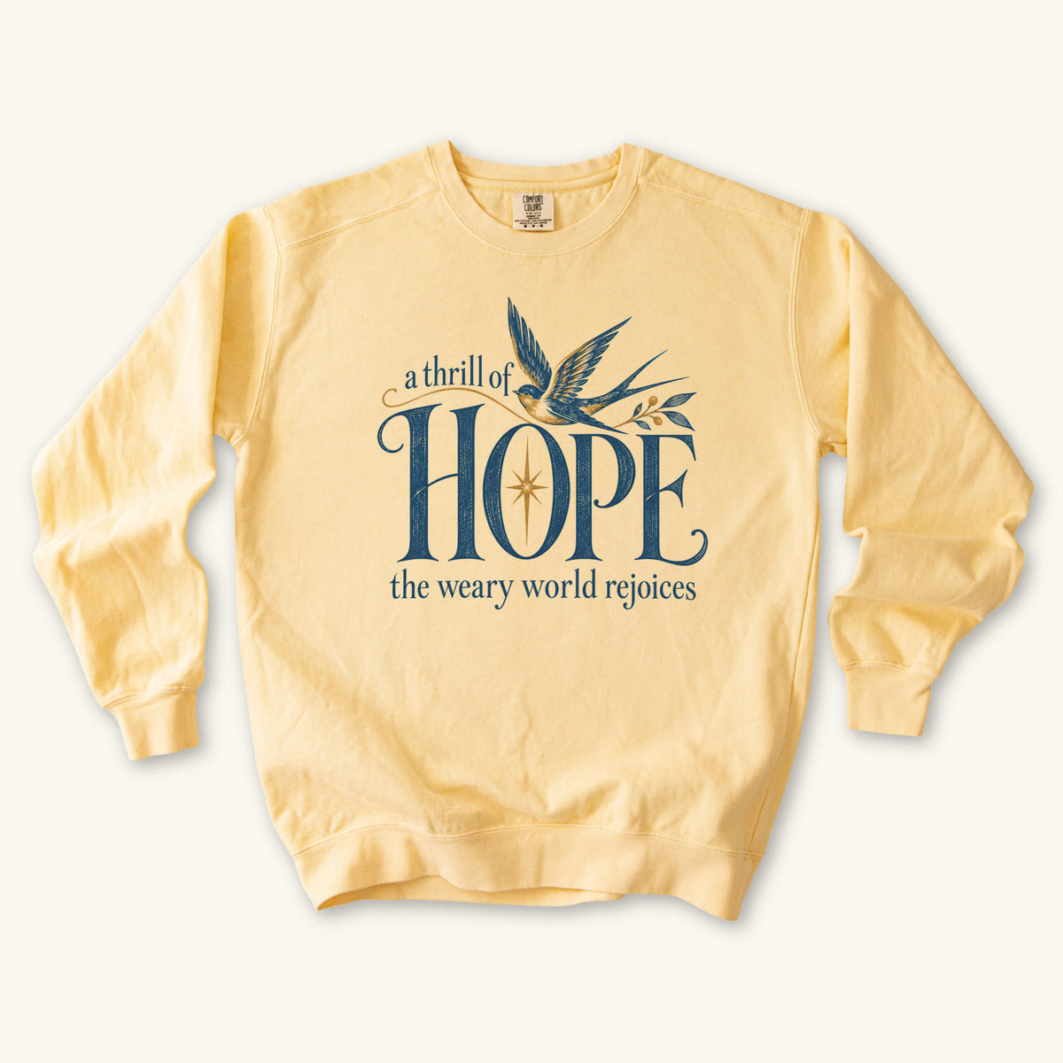 Butter Christian Christmas sweatshirt with A Thrill of Hope, the weary world rejoices lettering, a swallow and a star.