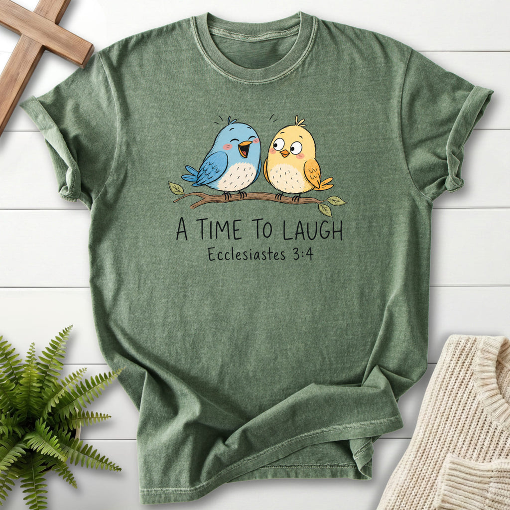 Flatlay of a Moss Comfort Colors 1717 garment-dyed Christian tee with "A Time To Laugh Faith Birds T-Shirt" Ecclesiastes 3:4 From Printify.