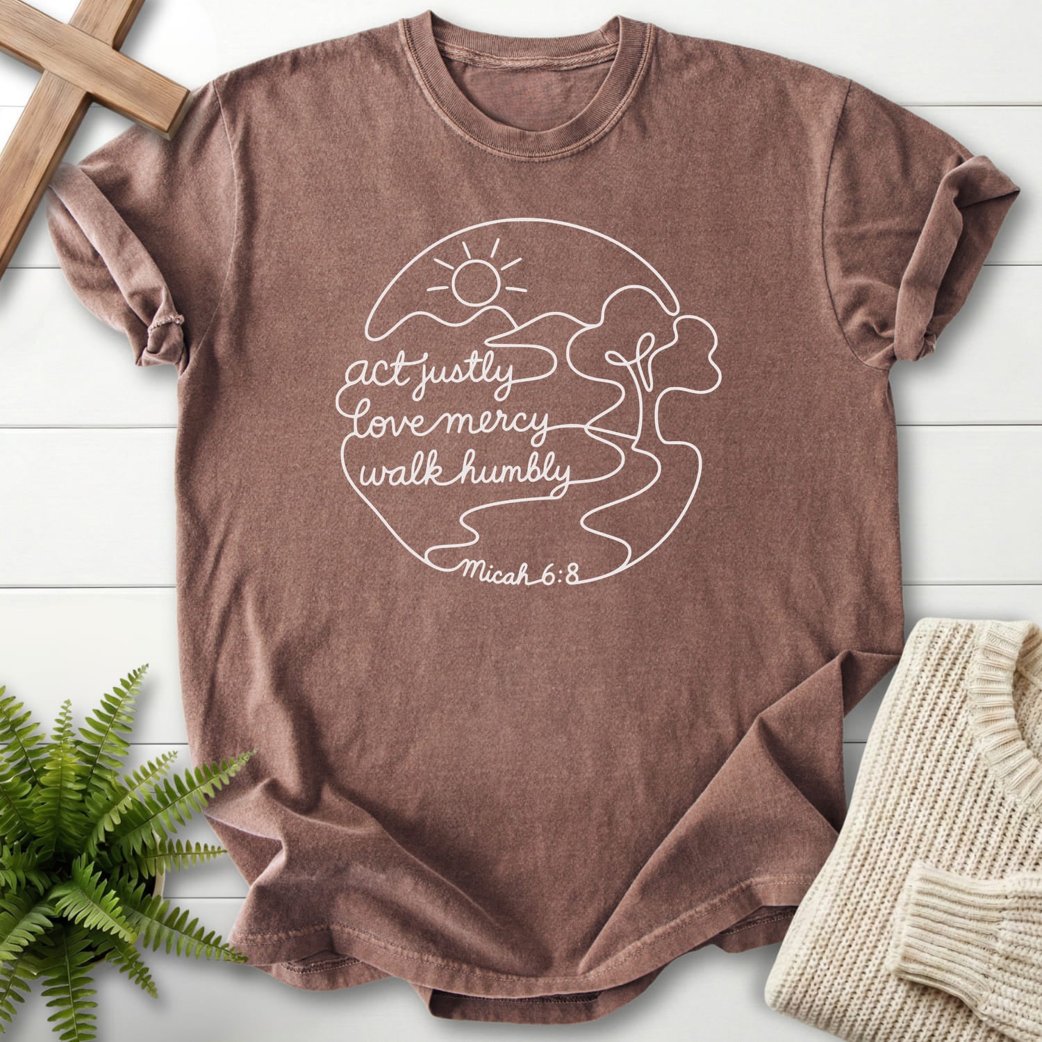 Flat lay of an Espresso women's Christian tee featuring sunrise graphic with "Act Justly Micah 6 8 Dark T-Shirt".