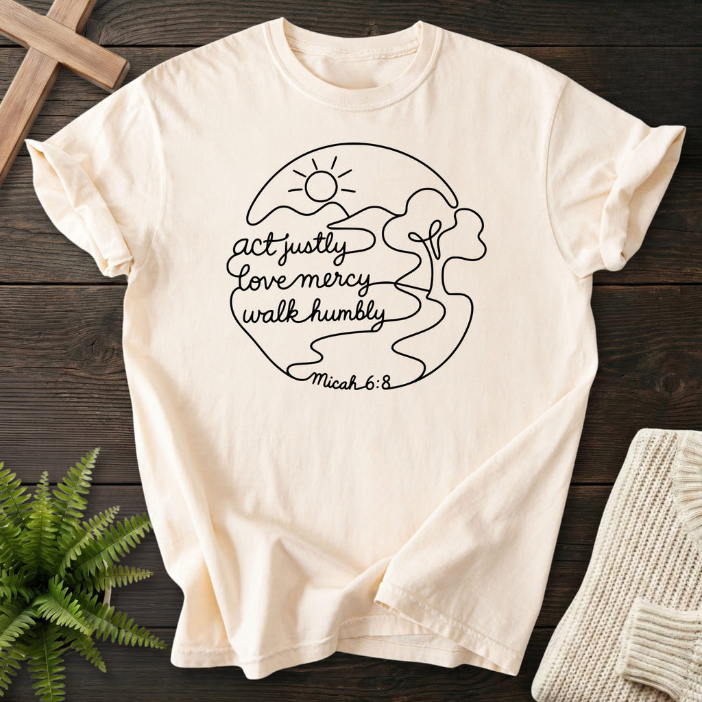 Flatlay of an Ivory faith-inspired shirt with sunrise graphic with "Act Justly Micah 6 8 Dark T-Shirt".