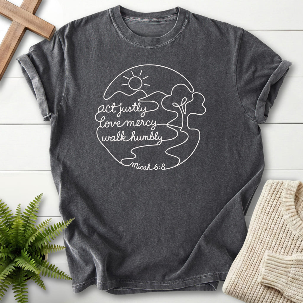 Flat lay of a Pepper Comfort Colors 1717 Christian t-shirt for women featuring sunrise graphic with "Act Justly Micah 6 8 Dark T-Shirt".