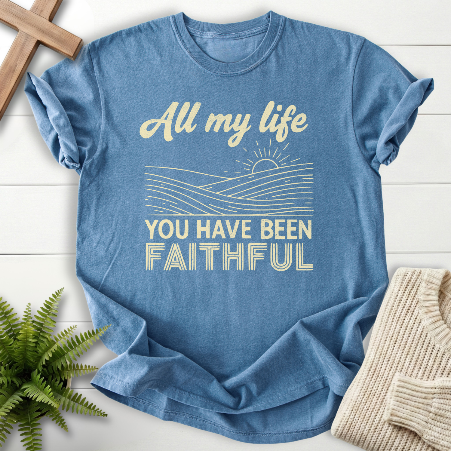 Blue Jean garment-dyed women's Christian tee with vintage hills and sunrise artwork featuring 'All My Life You Have Been Faithful'