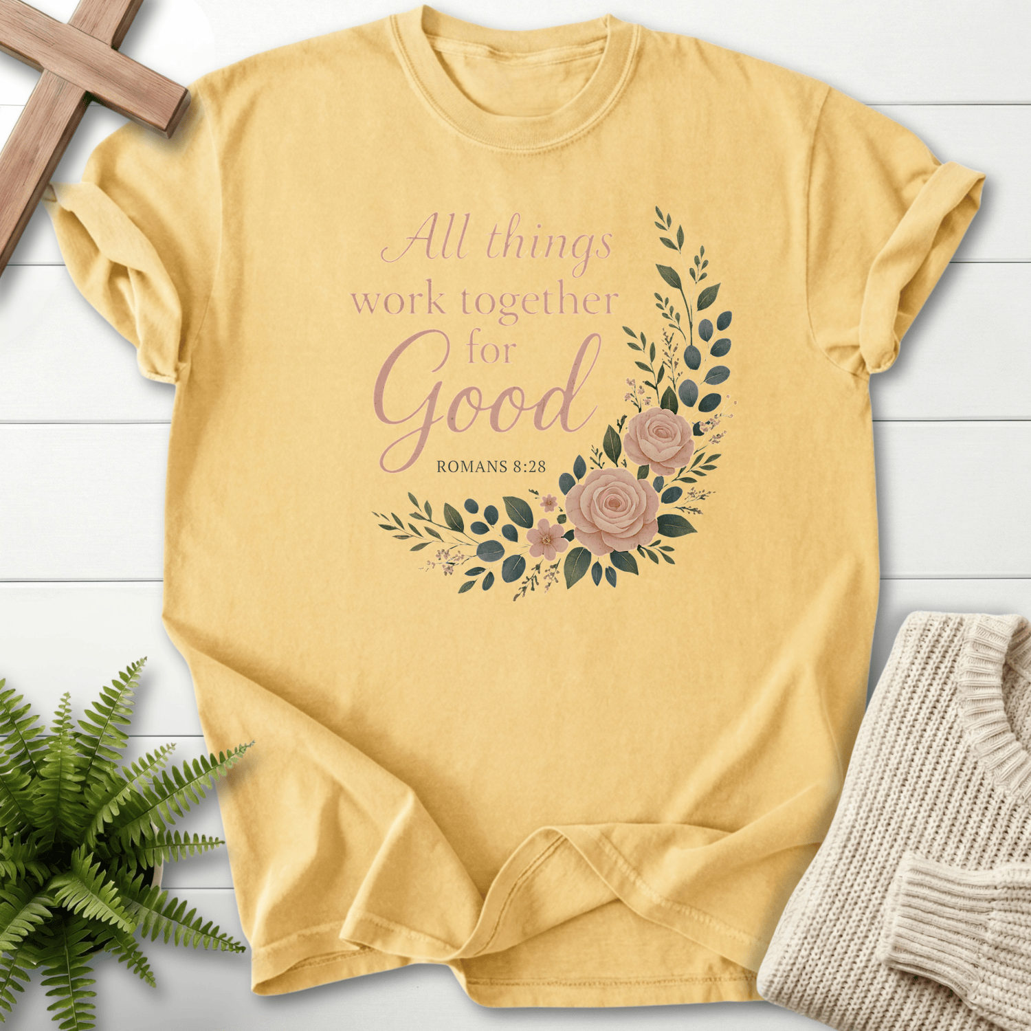 Butter yellow Christian t-shirt for women with a blush watercolor rose wreath and 'All Things Work Together for Good', inspired by Romans 8:28.