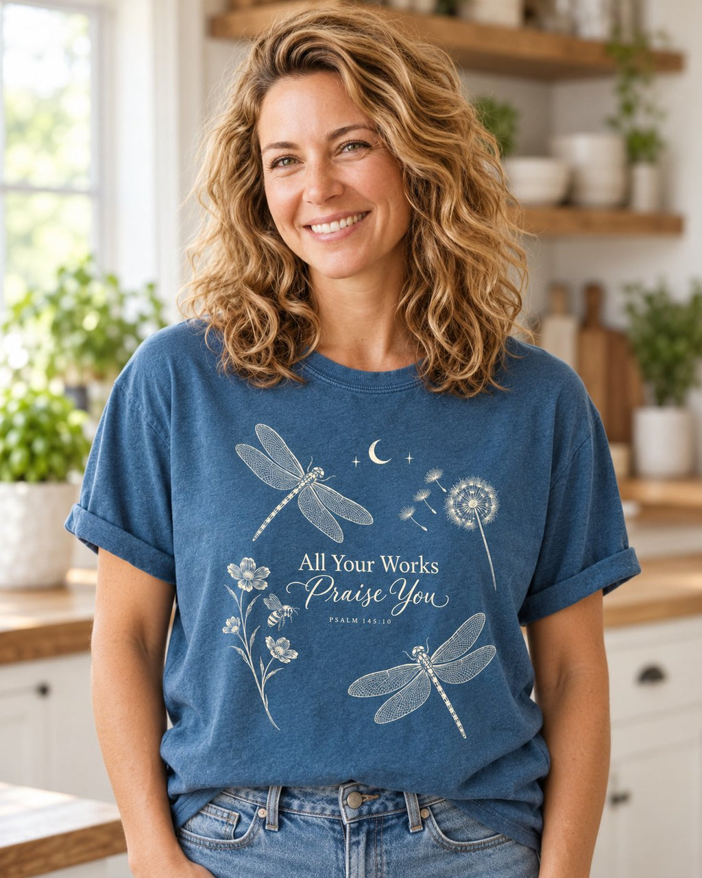 All Your Works Praise You, Midnight women's Christian tee, lifestyle photo in morning kitchen setting, Dragonflies and wildflowers around All Your Works Praise You script, She Wears Faith
