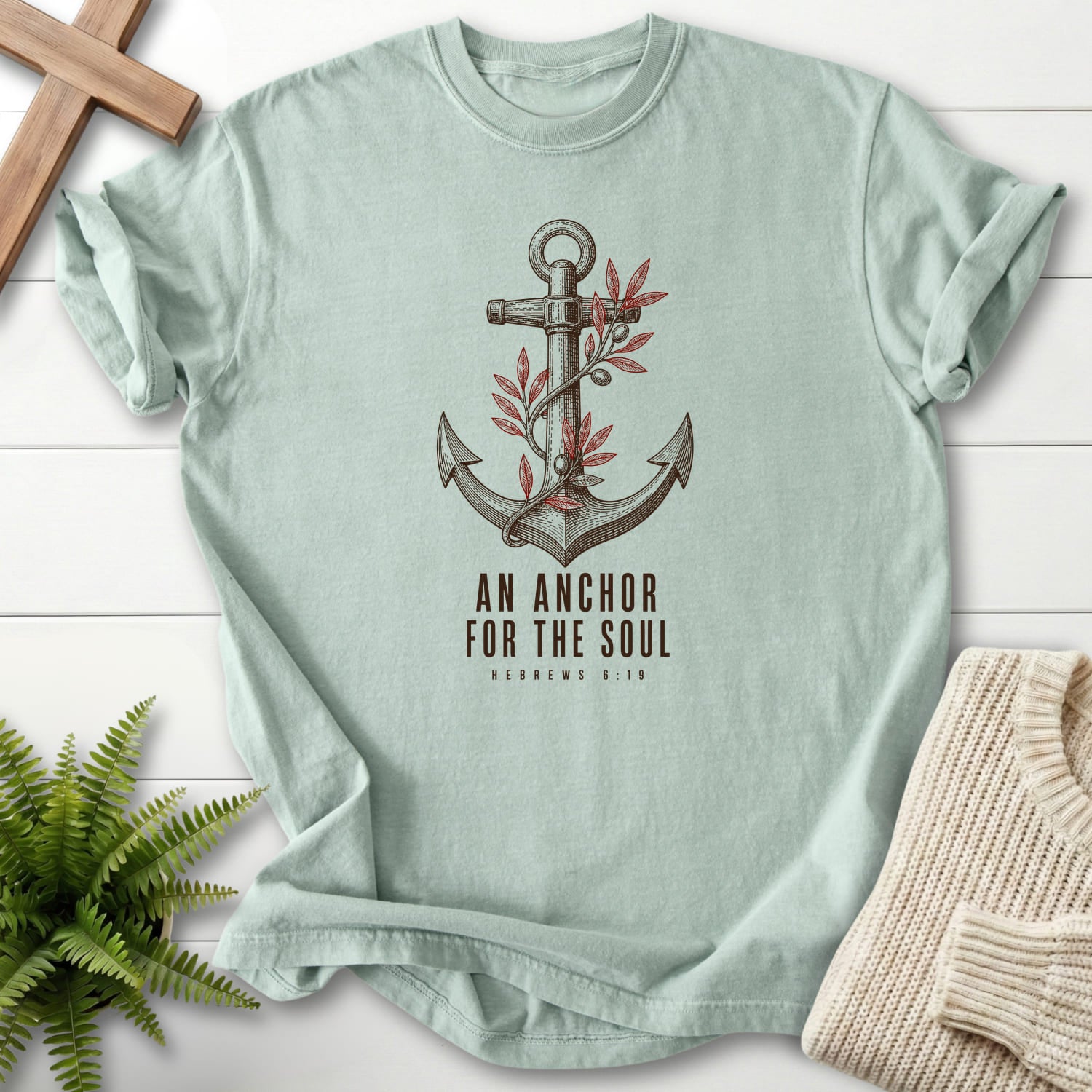 Flat lay of a Bay faith-based tee featuring "An Anchor for the Soul T-Shirt" Hebrews 6:19.