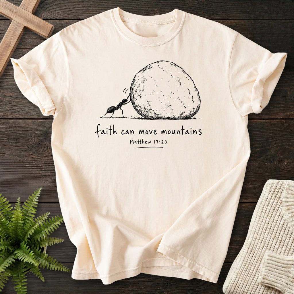 Flat lay of an Ivory Comfort Colors 1717 faith-based tee featuring "Ant and Boulder Faith T-Shirt" Matthew 17:20.