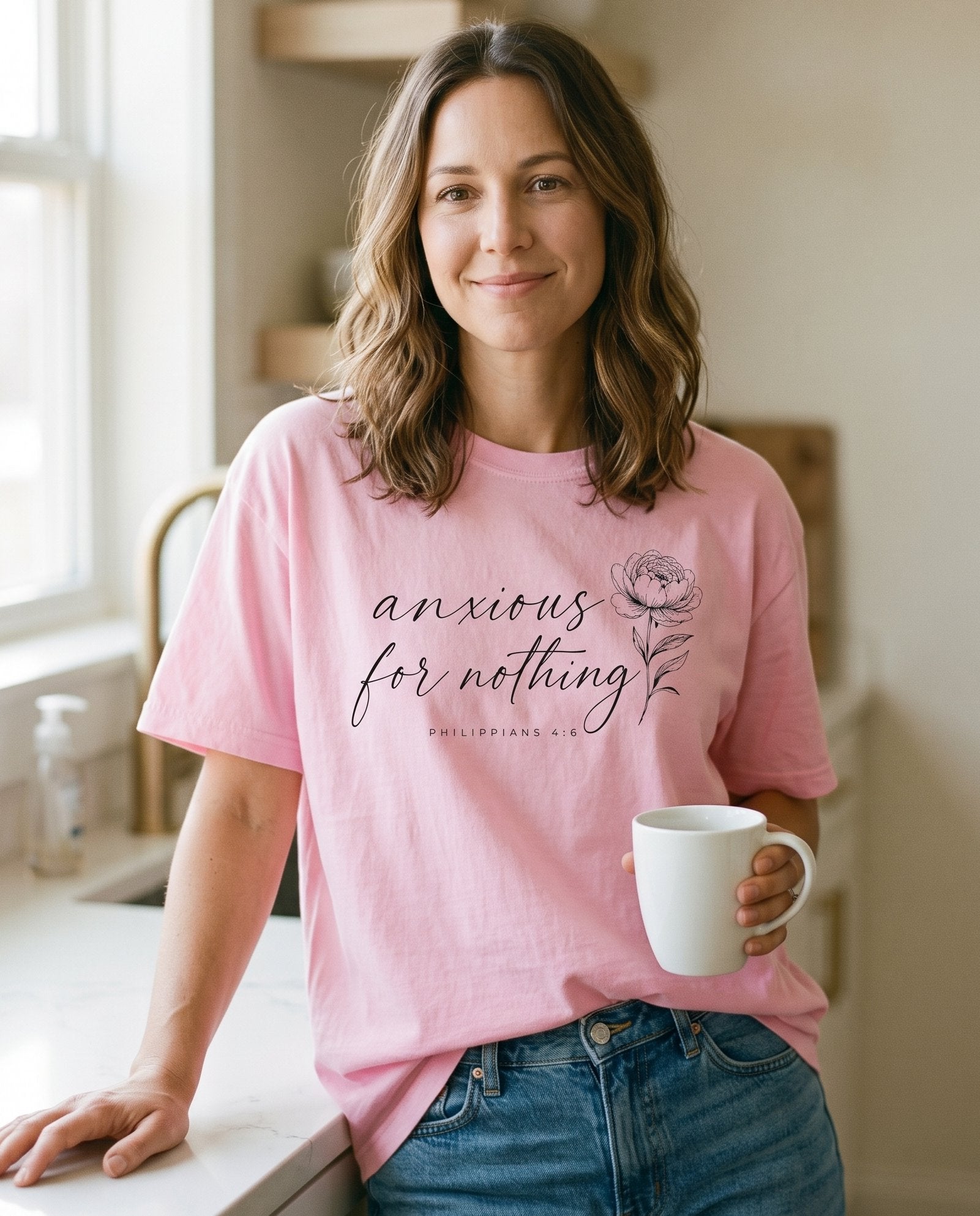 Anxious for Nothing Floral Script – Blossom women's Christian tee, lifestyle photo in morning kitchen setting – Black cursive script 'anxious for nothing' stacked across the chest – Philippians 4:6 – She Wears Faith