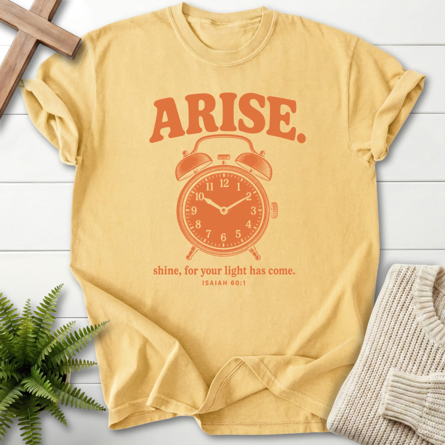 Flatlay of a Butter Christian graphic tee with "Arise and Shine Isaiah 60 1 T-Shirt" Isaiah 60:1.
