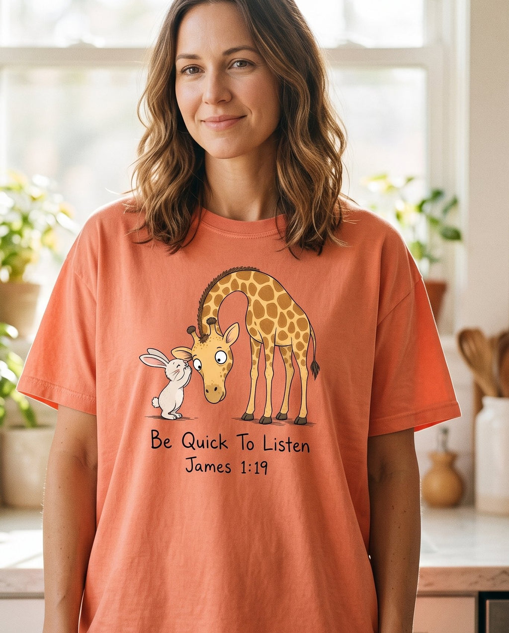 Be Quick To Listen James 1 19 – Terracotta women's Christian tee, lifestyle photo in morning kitchen setting – Cartoon giraffe bending its long neck down nose-to-nose with a tiny wi – James 1:19 – She Wears Faith