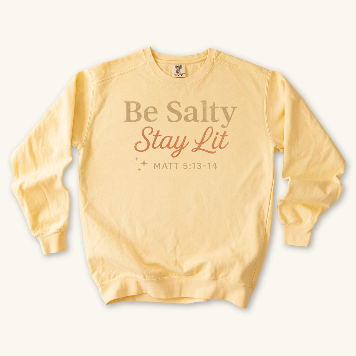 Butter Christian sweatshirt reading Be Salty Stay Lit in serif and script lettering with sparkles, Matthew 5:13-14