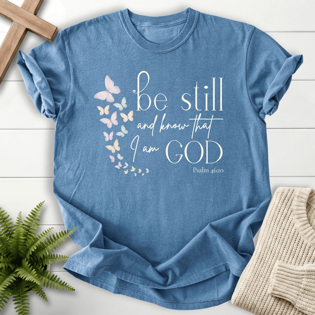Blue Jean Christian t-shirt for women with pastel butterfly artwork and 'Be Still and Know That I Am God', inspired by Psalm 46:10.