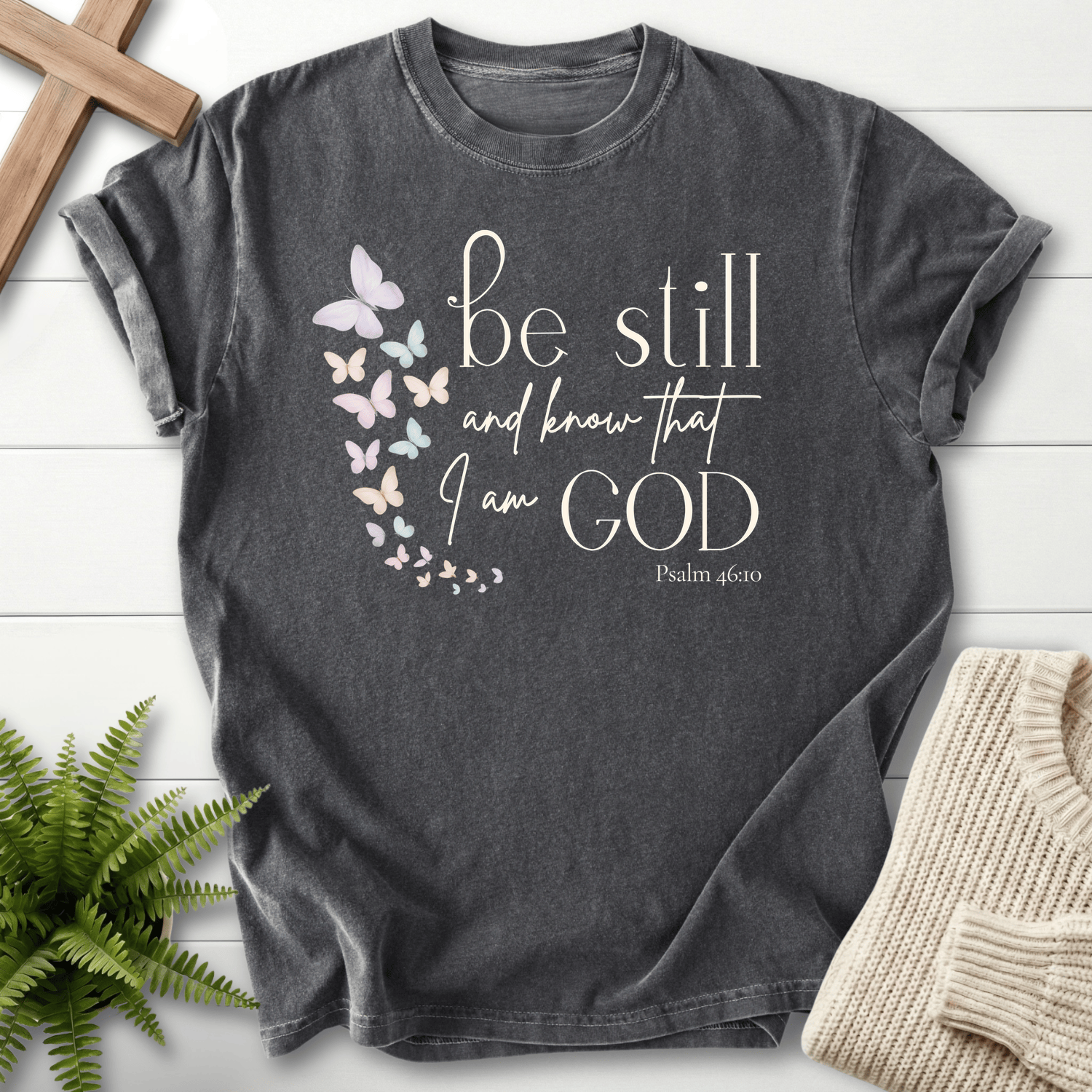 Pepper Christian t-shirt for women with a pink and purple butterfly trail and 'Be Still and Know', inspired by Psalm 46:10.