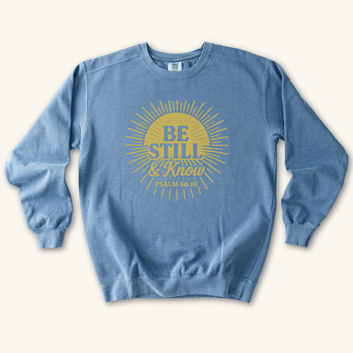 Blue Jean Be Still & Know Sunburst sweatshirt flat lay mockup, Psalm 46:10 Christian apparel for women