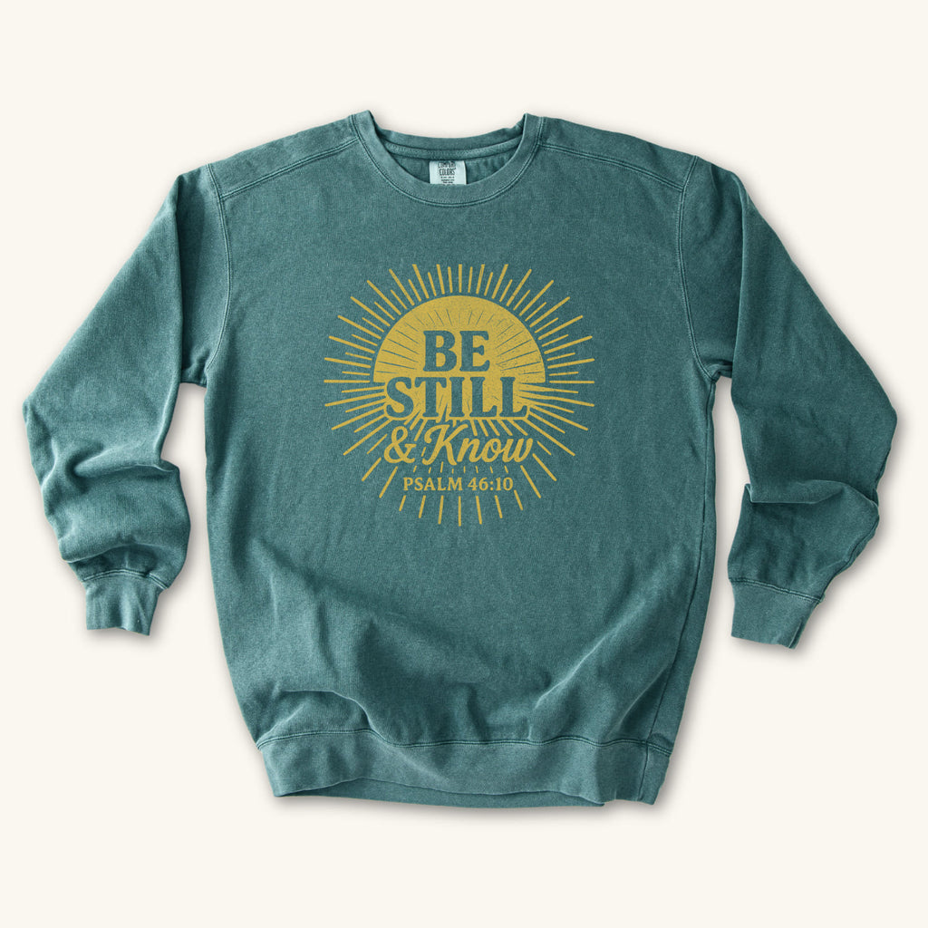 Blue Spruce Be Still & Know Sunburst sweatshirt flat lay mockup, Psalm 46:10 Christian apparel for women