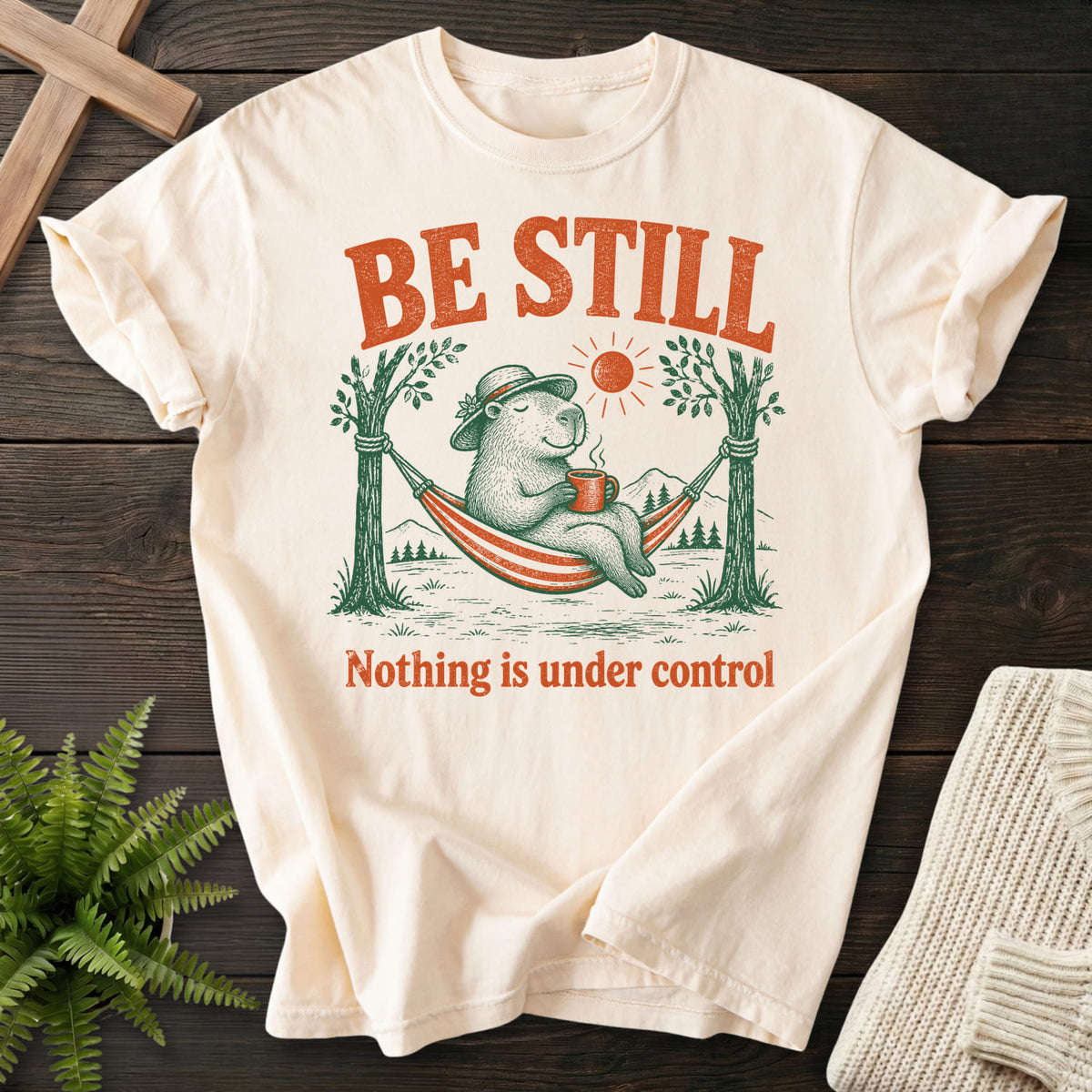 Ivory color option for the Be Still Capybara faith-based tee with capybara hammock graphic with "Be Still Capybara T-Shirt".