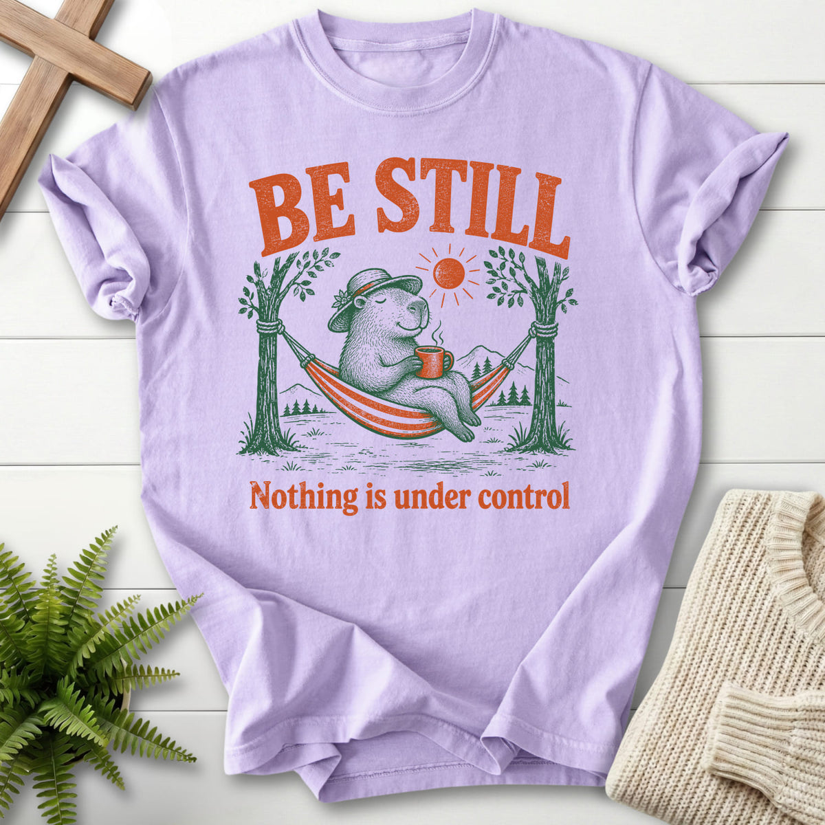 Orchid color option for the Be Still Capybara tee with capybara hammock graphic with "Be Still Capybara T-Shirt" for women's faith apparel.