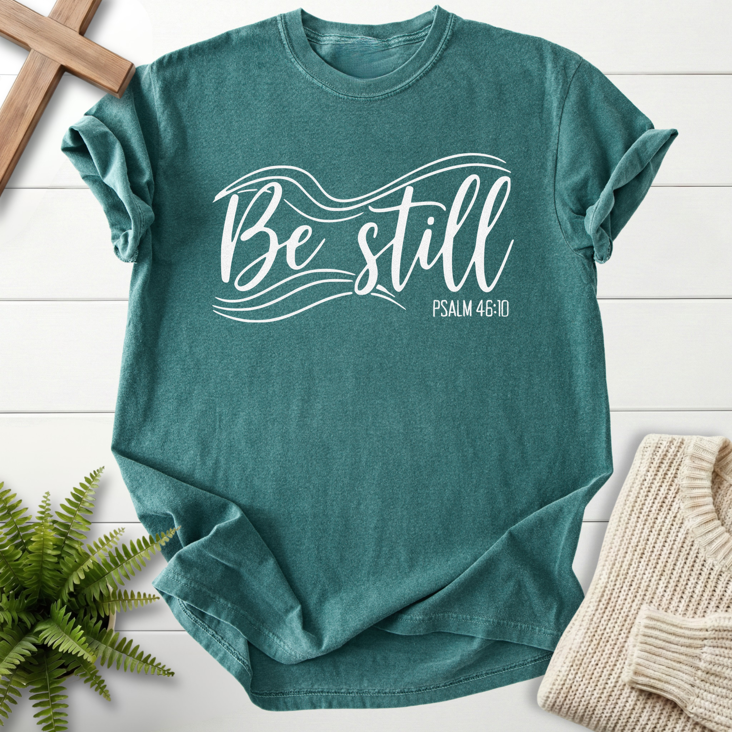 Blue Spruce Christian t-shirt for women with elegant flowing script, inspired by Psalm 46:10.
