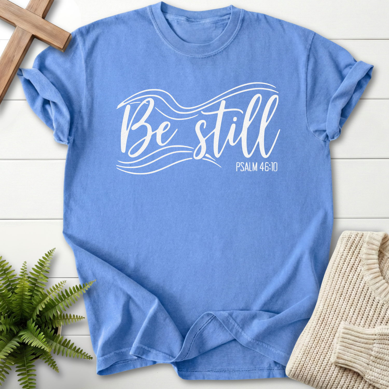 Mystic Blue Christian t-shirt for women with elegant white script and swoosh wave design, inspired by Psalm 46:10.