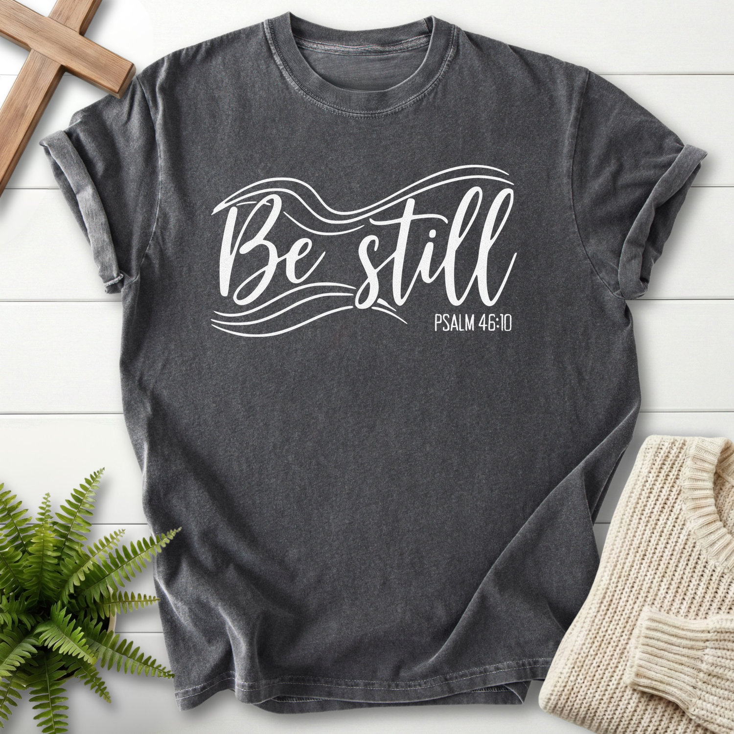 Pepper Christian t-shirt for women with white flowing script and wave accents, inspired by Psalm 46:10.