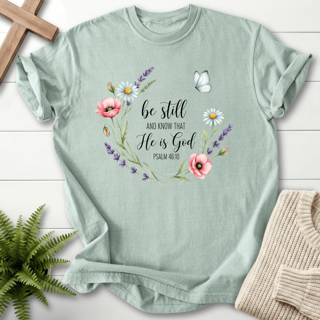 Bay Christian t-shirt for women with 'Be Still and Know That He Is God' and a floral wreath design, inspired by Psalm 46:10.