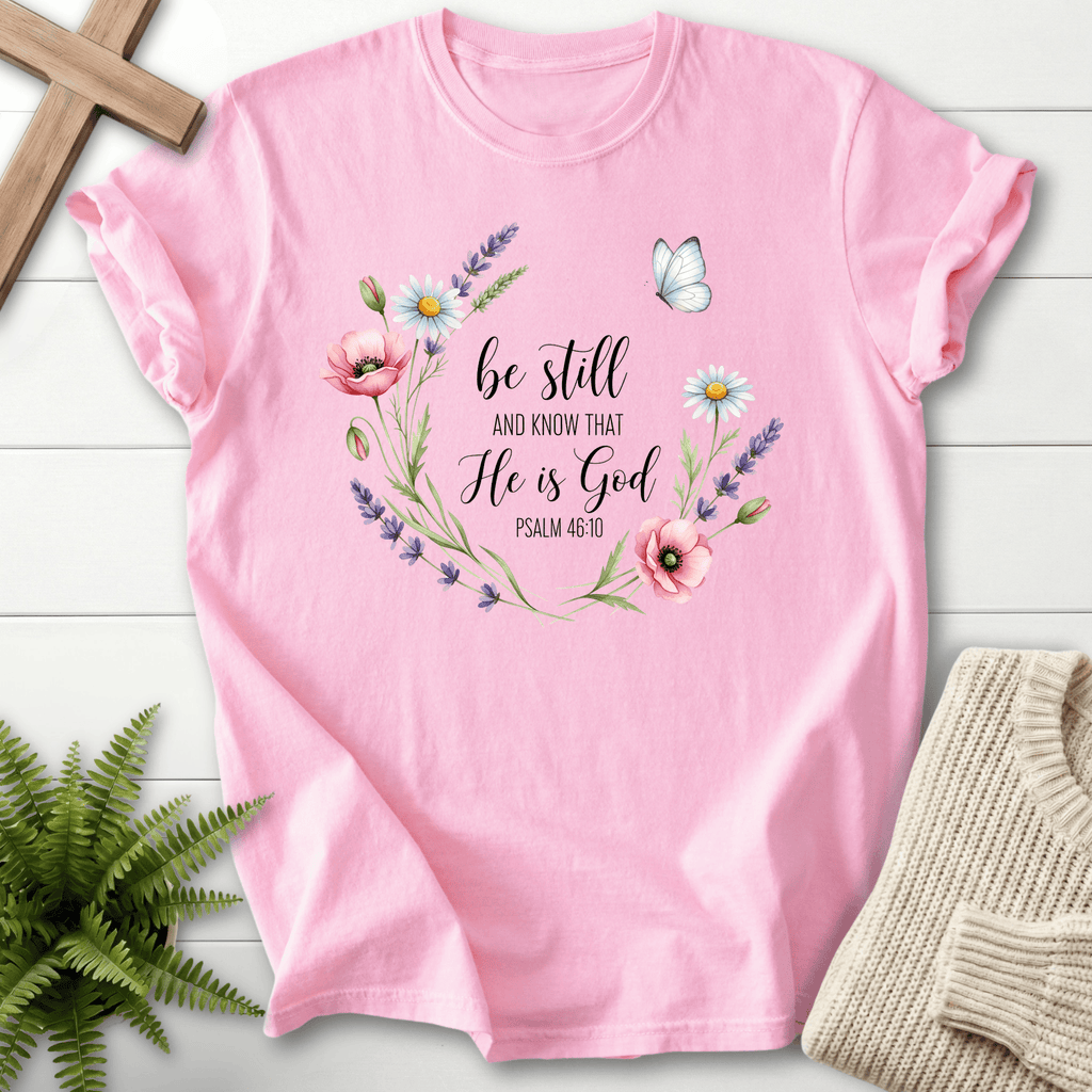 Blossom pink Christian t-shirt for women with a watercolor wildflower wreath and 'Be Still and Know He Is God', inspired by Psalm 46:10.