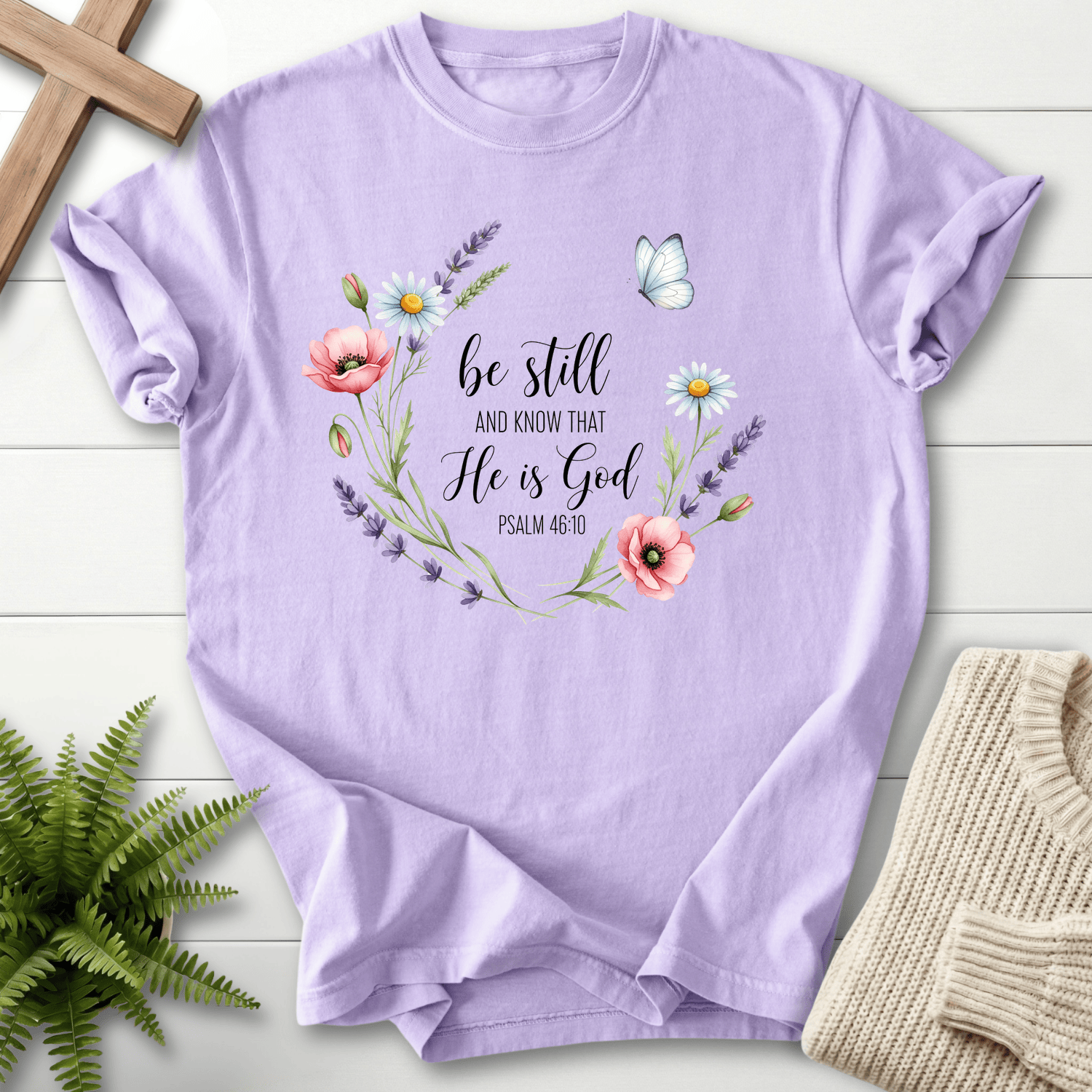 Orchid Christian t-shirt for women with a watercolor wildflower wreath design, She Wears Faith, inspired by Psalm 46:10.