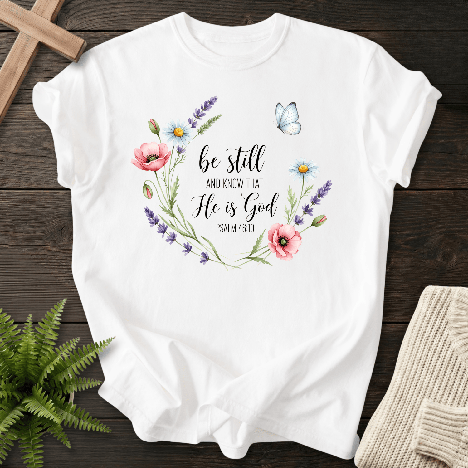 White Christian t-shirt for women with a watercolor wildflower wreath, inspired by Psalm 46:10.