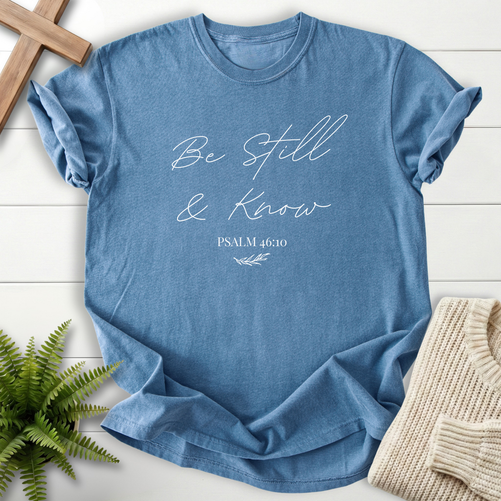 Blue Jean garment-dyed Christian t-shirt for women with elegant 'Be Still and Know' lettering and Psalm 46:10
