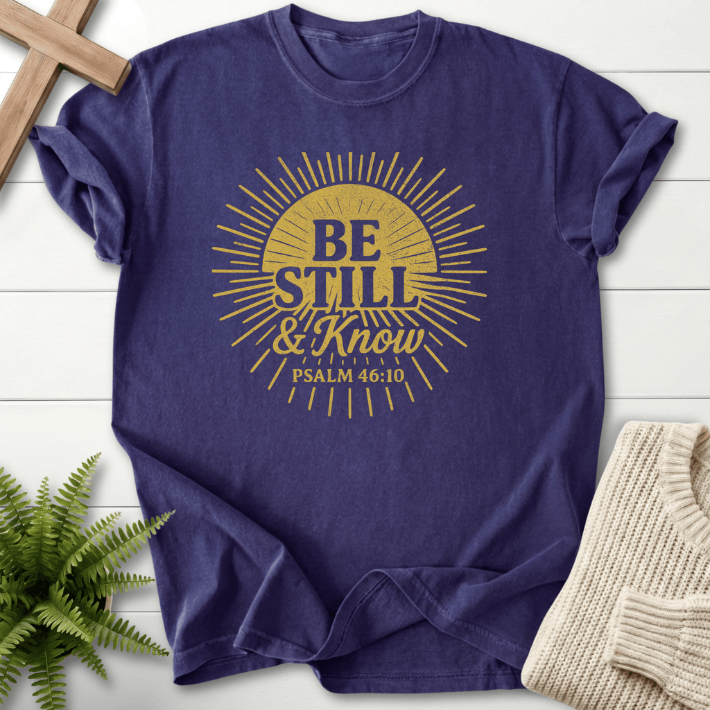 Grape Christian t-shirt for women with a distressed gold sunburst and 'Be Still and Know That I Am God'.