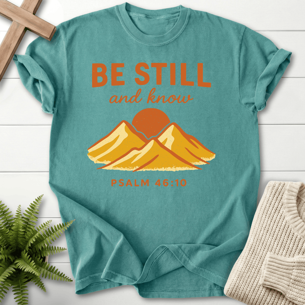 Chalky Mint Christian t-shirt for women with a retro mountain sunrise scene and 'Be Still and Know', inspired by Psalm 46:10.
