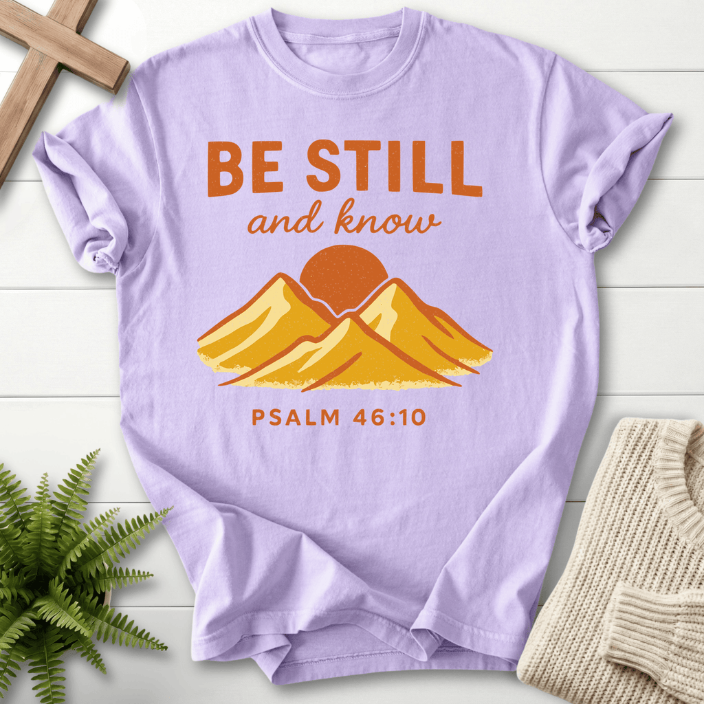 Orchid Christian t-shirt for women with a retro mountain and golden sunrise graphic, inspired by Psalm 46:10.