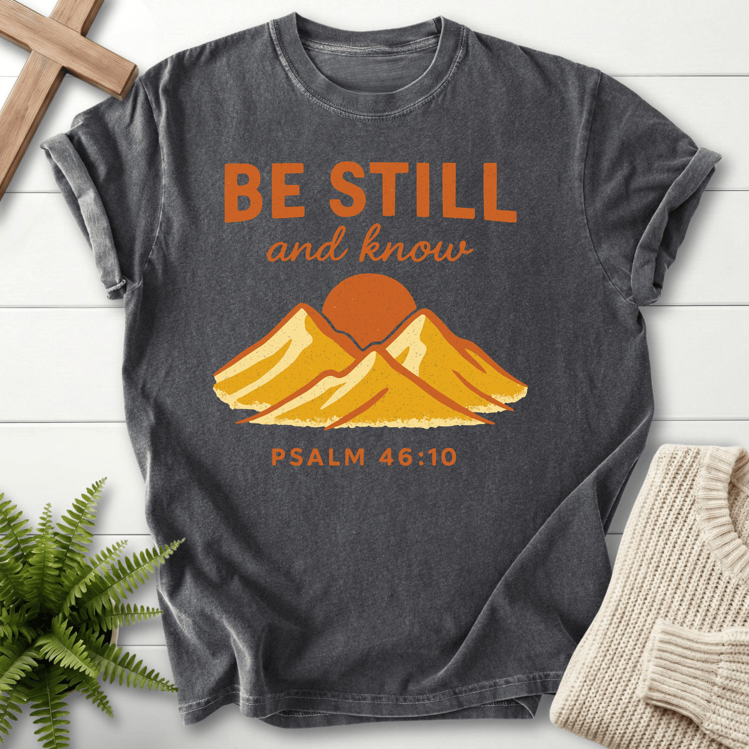 Pepper Christian t-shirt for women with a bold mountain landscape and retro 'Be Still and Know', inspired by Psalm 46:10.