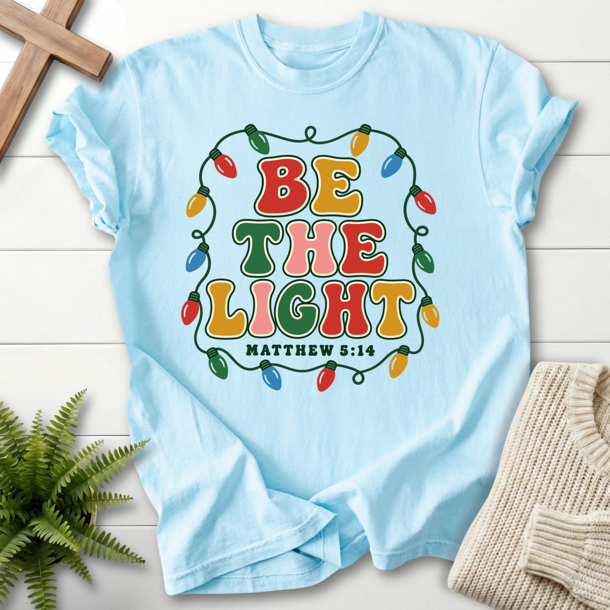 Chambray Be the Light Christmas Lights T-shirt flat lay mockup, Matthew 5:14 Christian apparel for women