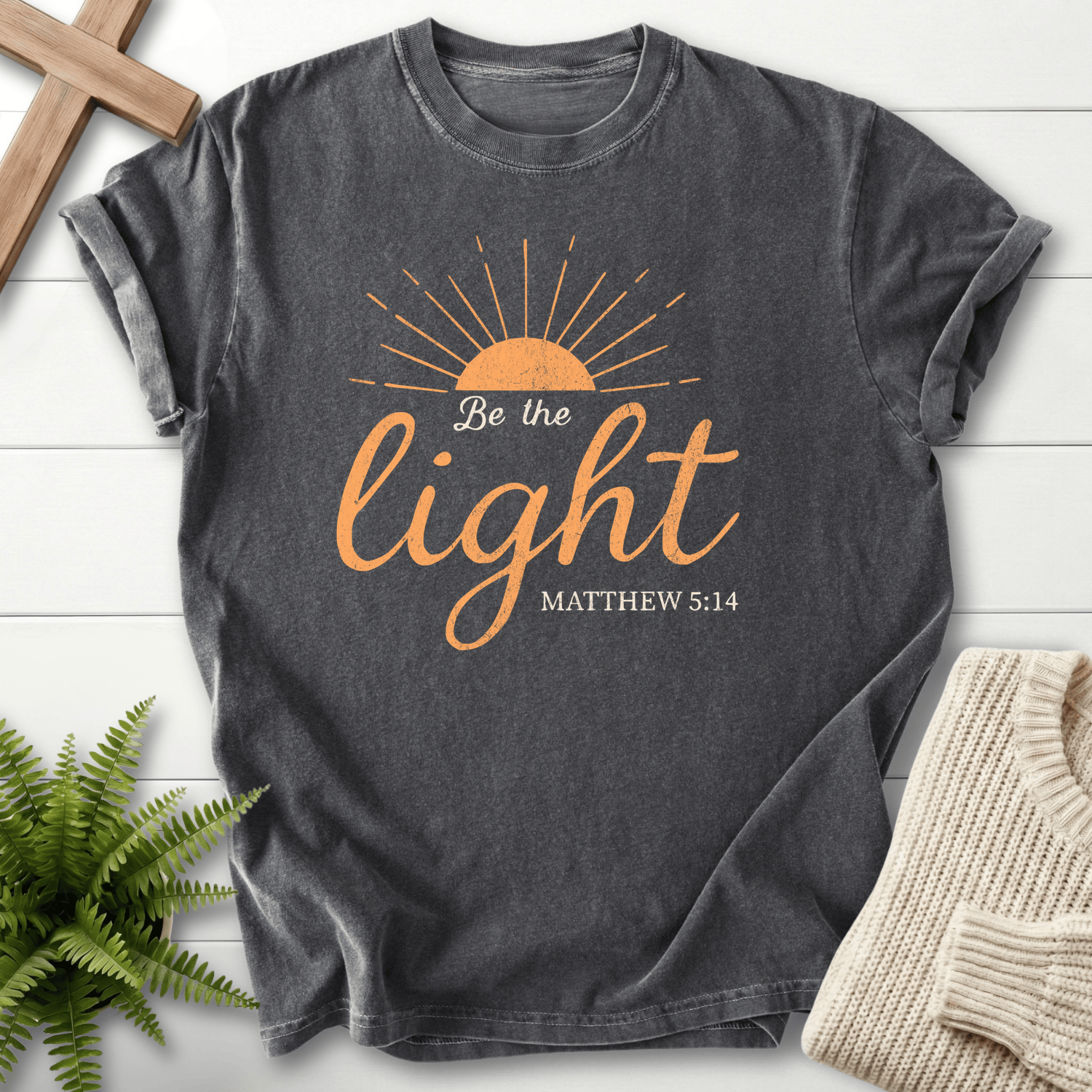 Pepper Christian t-shirt for women with a half-sun and gold cursive script design and 'Be the Light'.