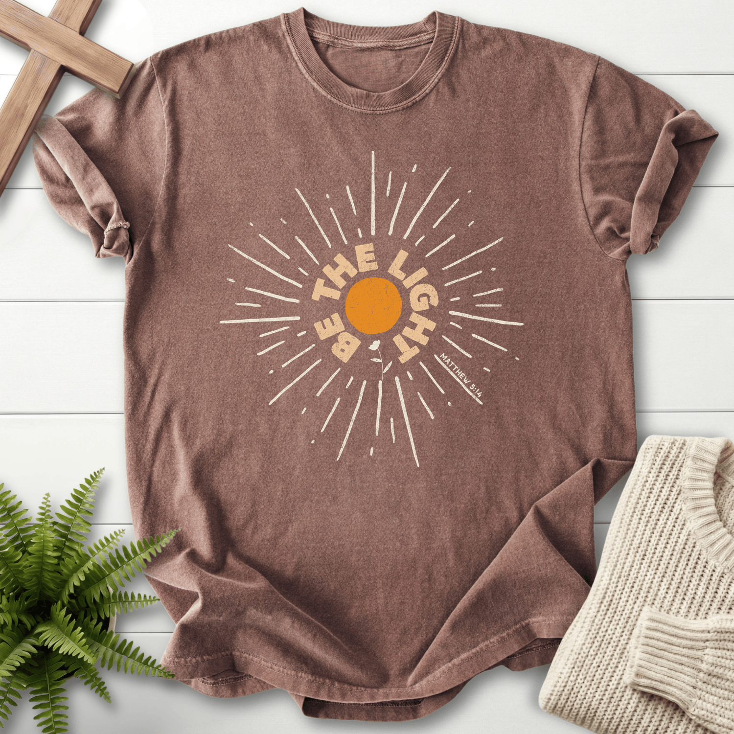 Espresso Christian t-shirt for women with a distressed sunburst illustration and 'Be the Light', inspired by Matthew 5:14.