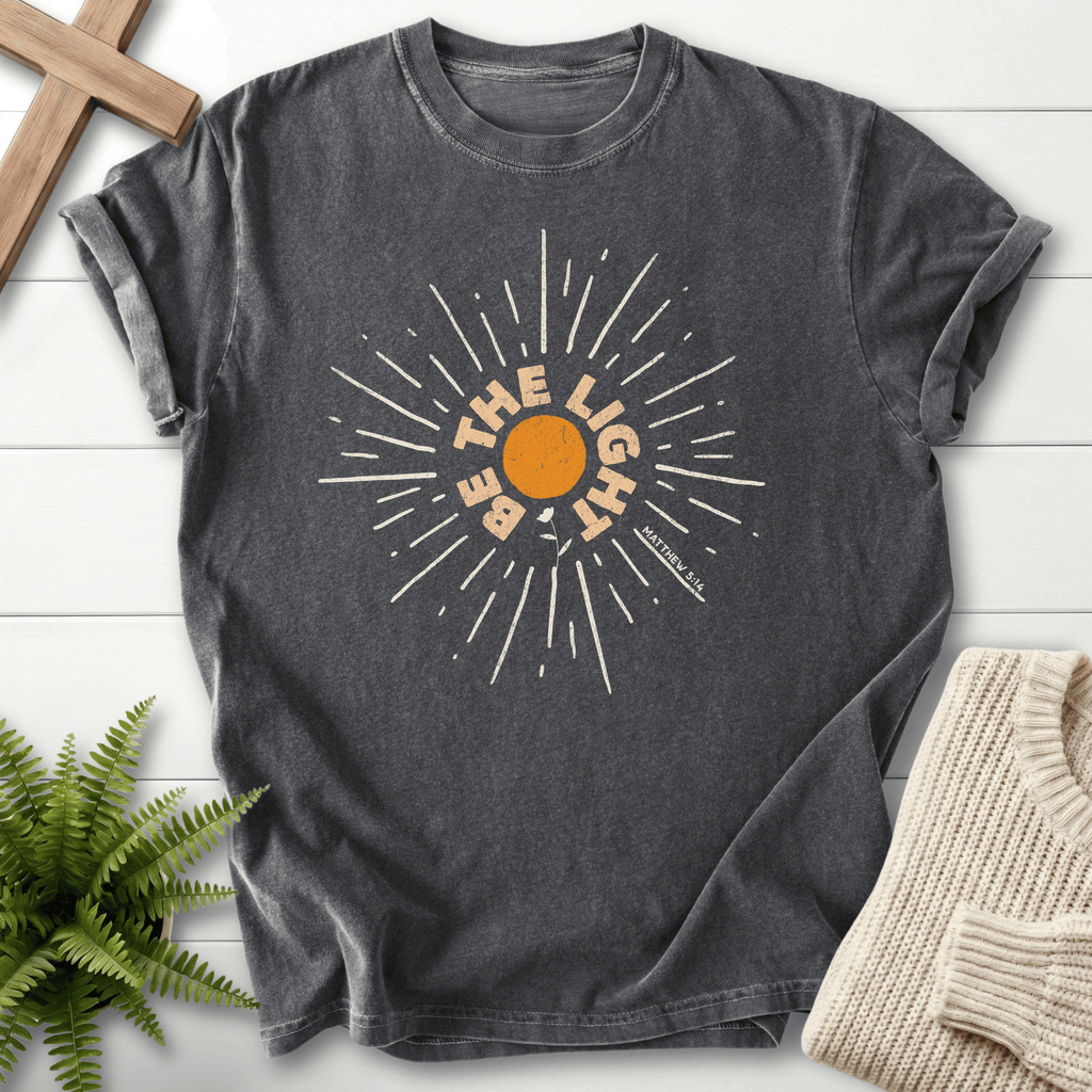 Pepper Christian t-shirt for women with a vintage sunburst and radiating lines design and 'Be the Light', inspired by Matthew 5:14.