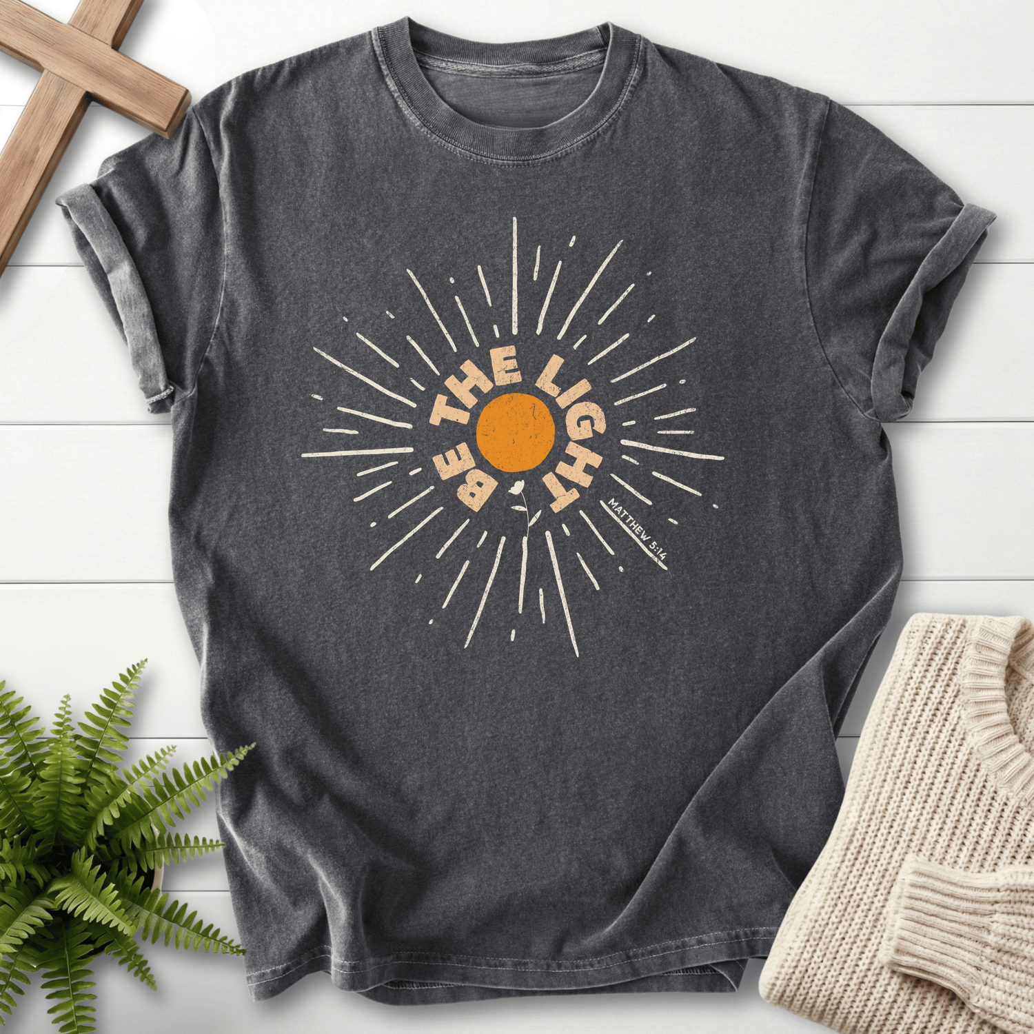 Pepper Christian t-shirt for women with a vintage sunburst and radiating lines design and 'Be the Light', inspired by Matthew 5:14.