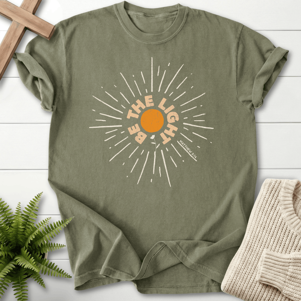 Sage Christian t-shirt for women with a bold circular sunburst and 'Be the Light', inspired by Matthew 5:14.