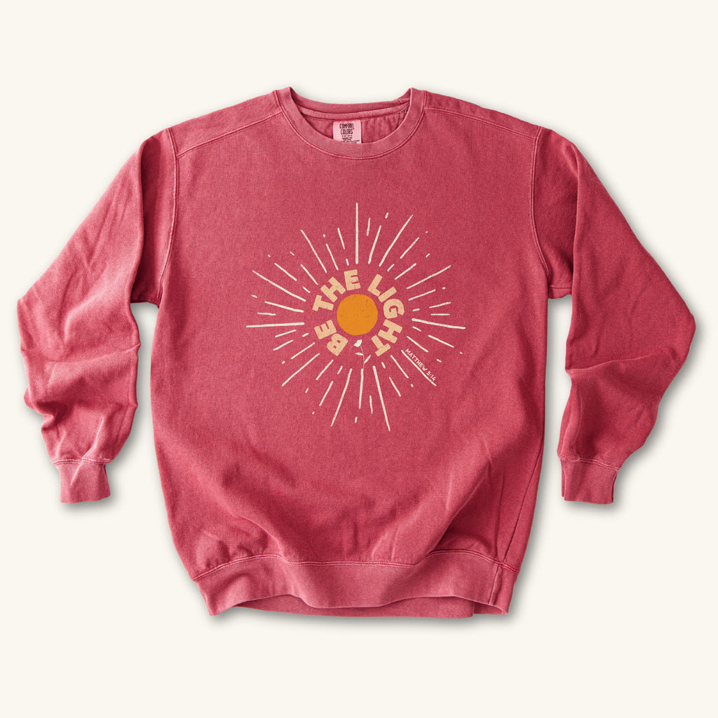 Crimson Be The Light Sunburst sweatshirt flat lay mockup, Matthew 5:14 Christian apparel for women