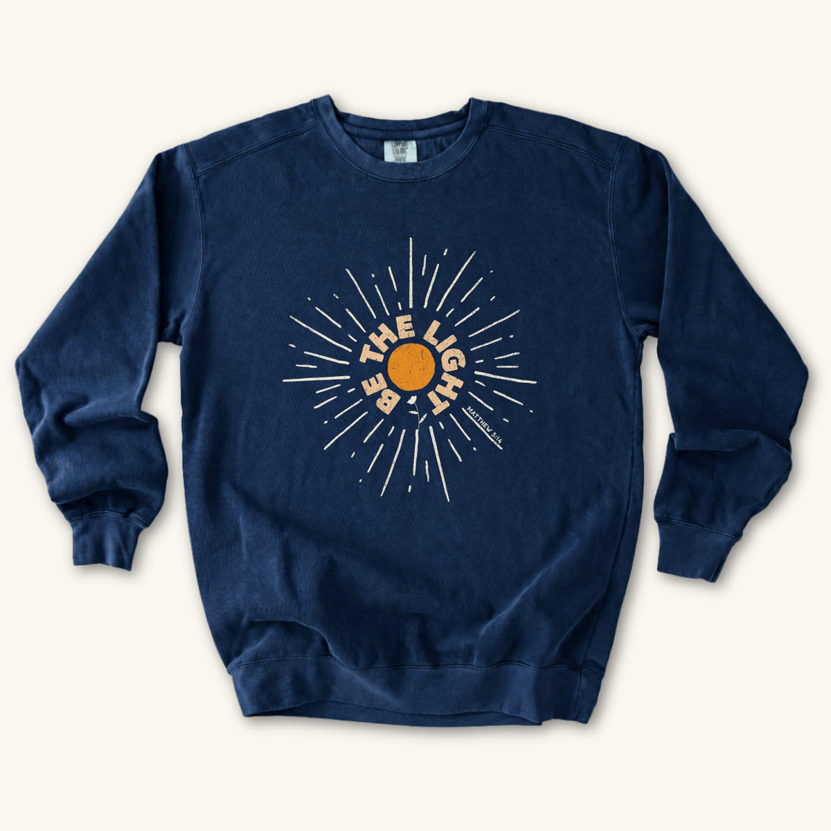 True Navy Be The Light Sunburst sweatshirt flat lay mockup, Matthew 5:14 Christian apparel for women