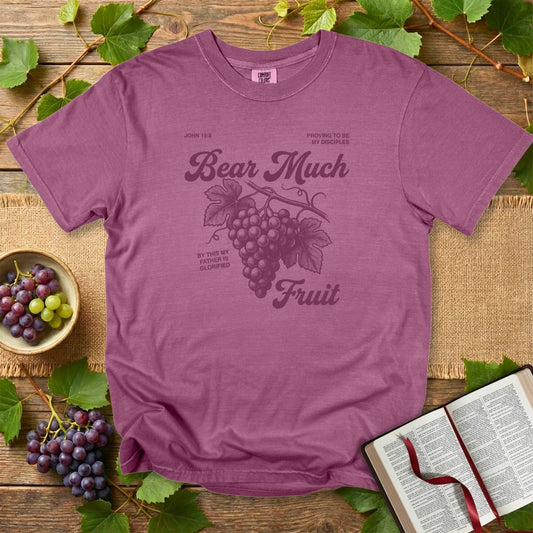 Berry Comfort Colors 1717 Christian women tshirt displaying the “Bear Much Fruit” John 15:8 grape design, photographed with natural vineyard-inspired props for an uplifting US faith wear look.