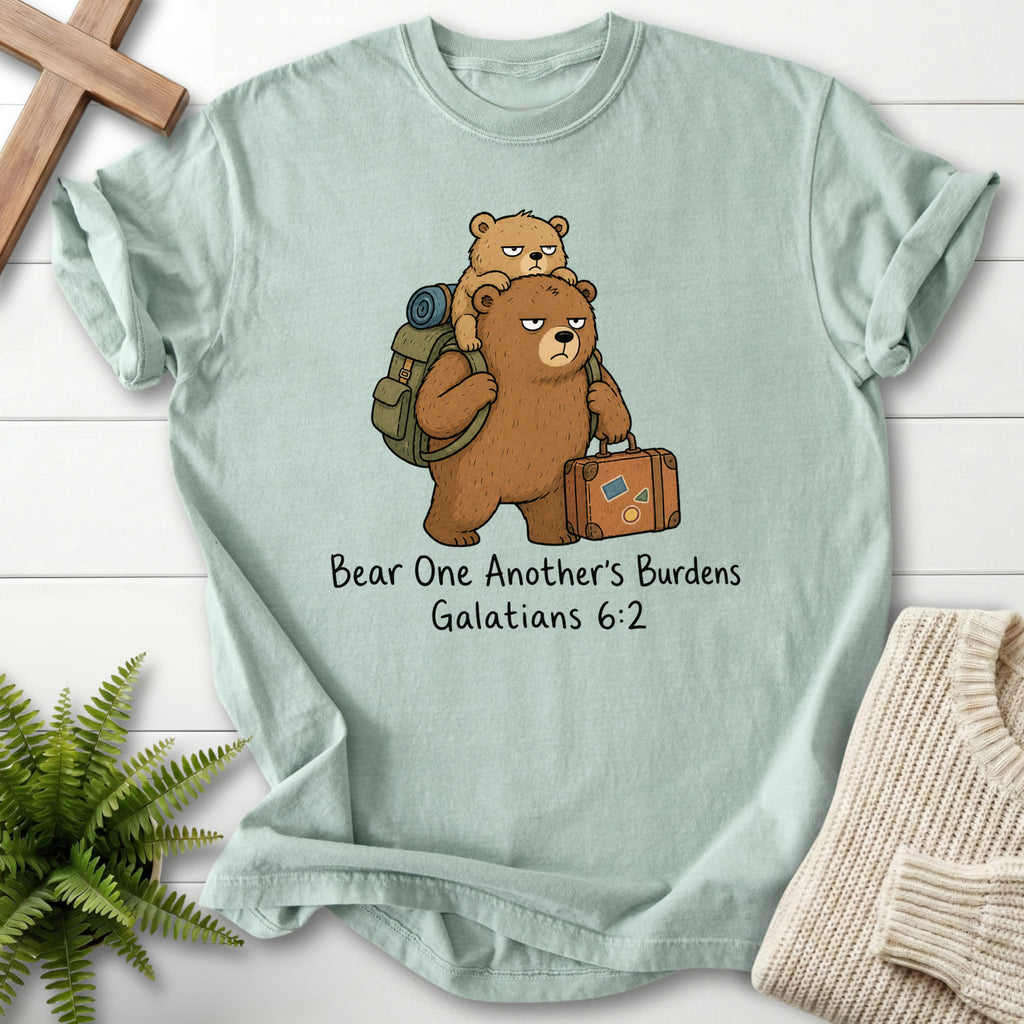 Flat lay of a Bay Christian graphic tee featuring "Bear One Another's Burdens T-Shirt" Galatians 6:2.
