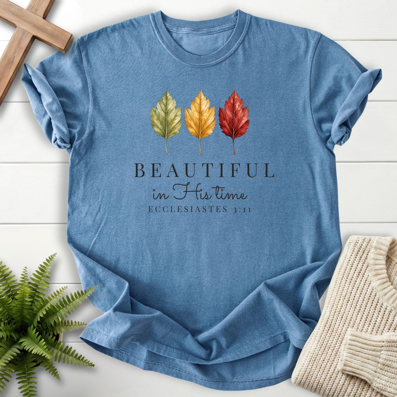 Flatlay of a Blue Jean faith-inspired shirt with "Beautiful in His Time T-Shirt" Ecclesiastes 3:11.