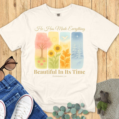 Comfort Colors 1717 ivory “He Has Made Everything Beautiful in Its Time – Ecclesiastes 3:11” t-shirt with pastel seasonal artwork symbolizing God’s perfect timing. A modern Christian shirt and thoughtful Christian mom gift idea.