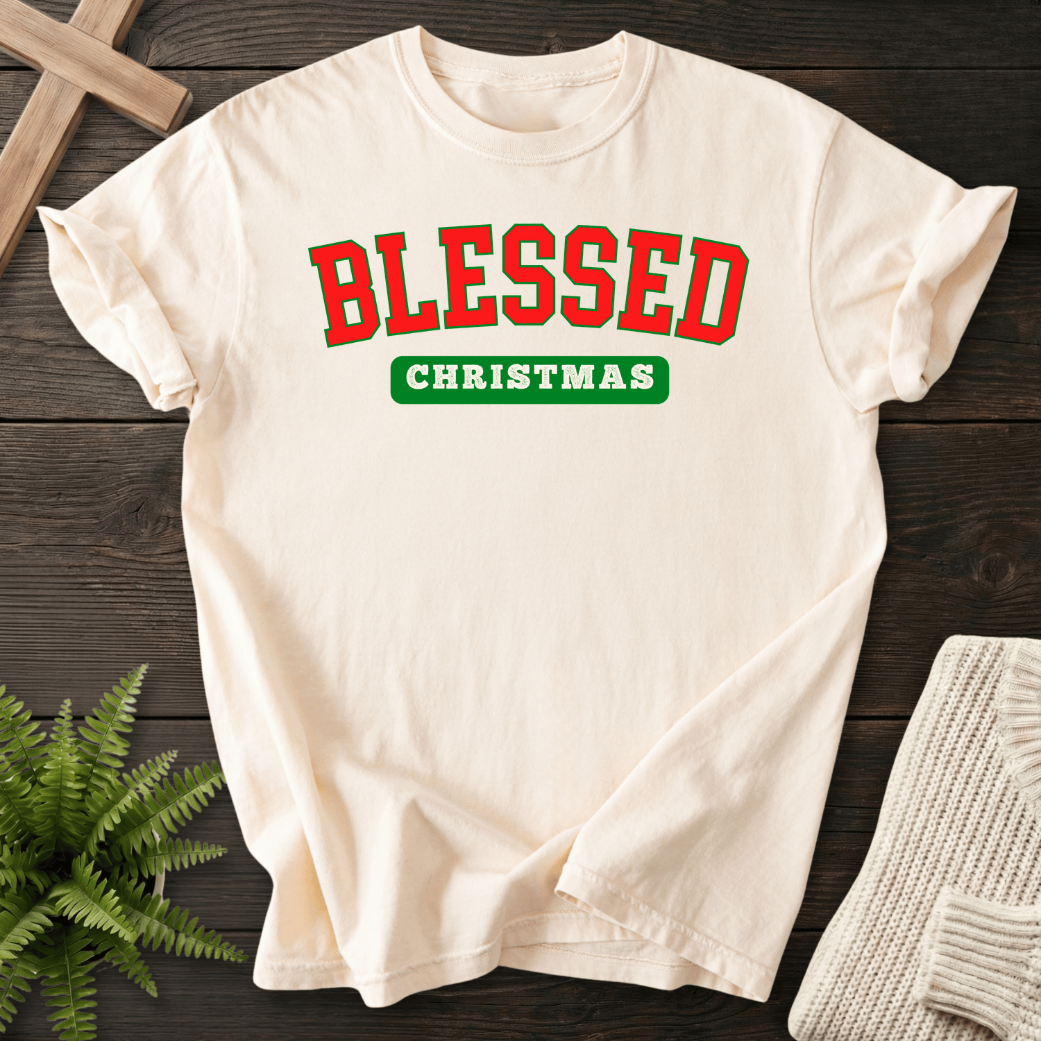 Ivory Christian t-shirt for women with bold red and green varsity block lettering and 'Blessed Christmas'.