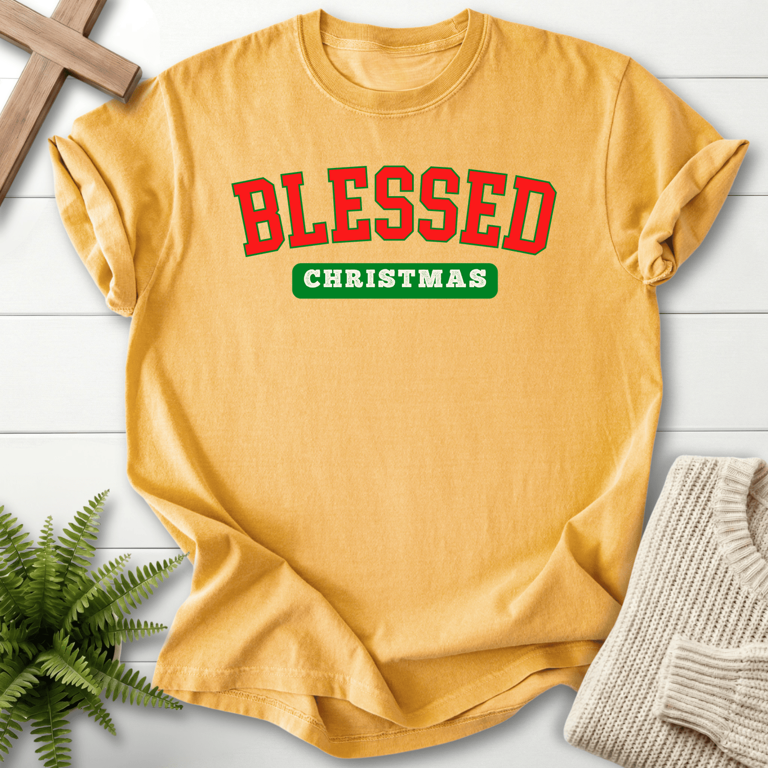 Mustard Christian t-shirt for women with varsity block lettering in festive red and green and 'Blessed Christmas'.