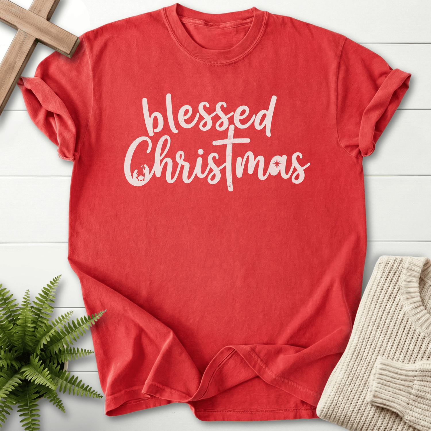 Red Christian t-shirt for women with handwritten 'blessed Christmas' script and a cross-styled T design.