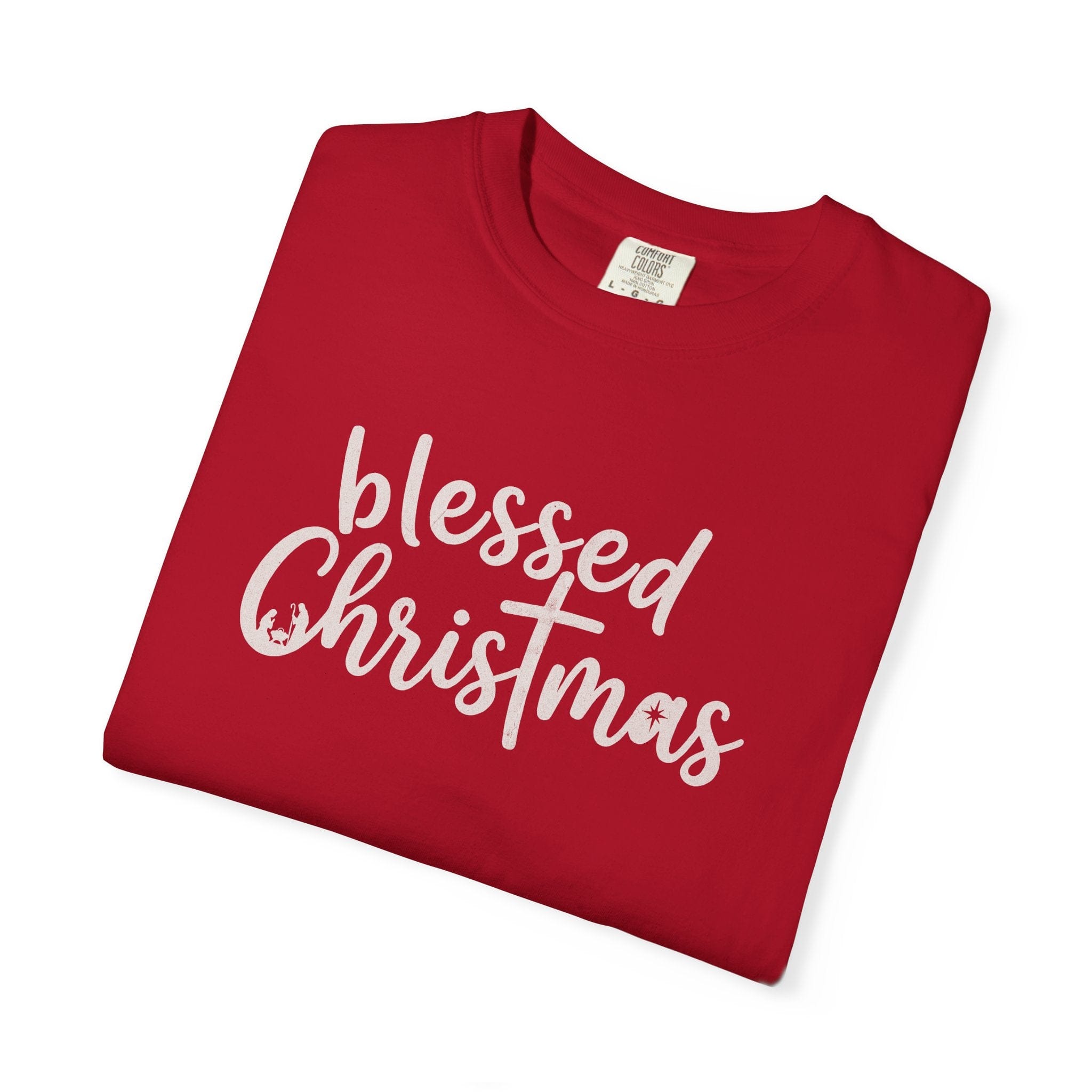 Folded red t-shirt with 'blessed Christmas' text on a white background