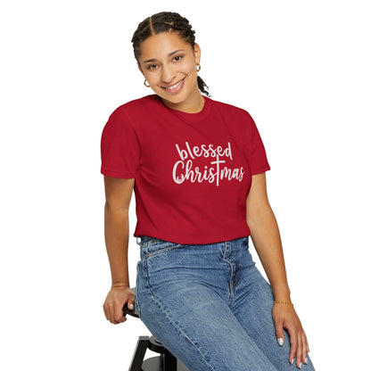 Person wearing a red 'blessed Christmas' t-shirt on a white background