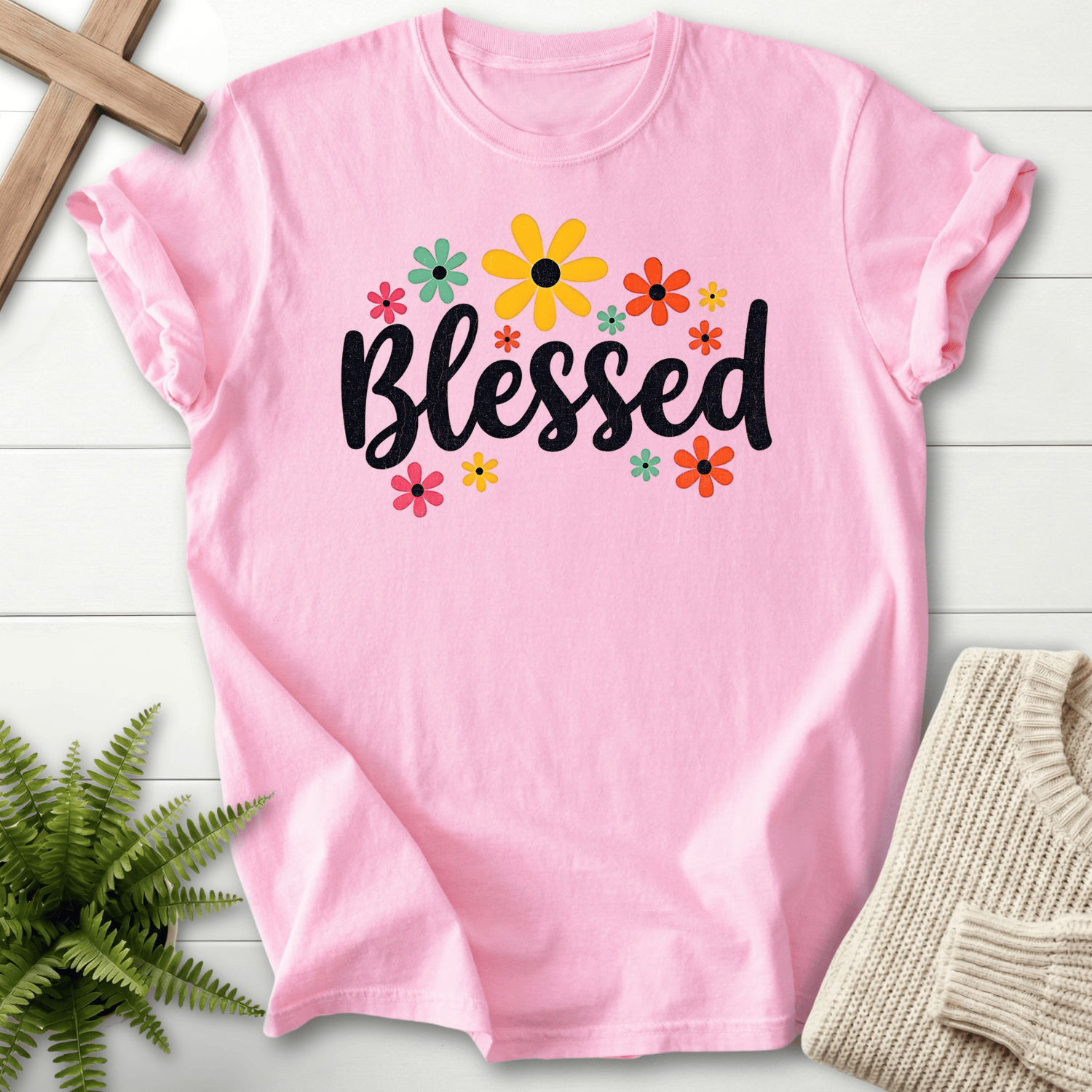 Blossom Christian t-shirt for women with bold black 'Blessed' script and a colorful retro floral arrangement.